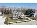 Aerial view showcasing the home's manicured lawn, long driveway, and proximity to neighboring houses at 78 Chatham Brook Dr, Westfield, IN 46074