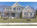 Charming two-story home featuring a stone facade, inviting front porch, and beautifully landscaped front yard at 78 Chatham Brook Dr, Westfield, IN 46074