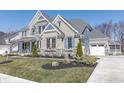 Gorgeous two-story home with stone and brick accents, a cozy front porch, and a spacious driveway at 78 Chatham Brook Dr, Westfield, IN 46074