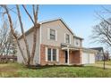 Two-story house with brick and siding exterior, two-car garage, and landscaped lawn at 7820 Bryden Dr, Fishers, IN 46038