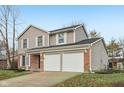 Two-story house with brick and siding exterior, two-car garage, and landscaped lawn at 7820 Bryden Dr, Fishers, IN 46038