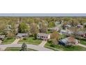 Scenic aerial view of a home nestled in a quiet neighborhood with mature trees and well-maintained lawns at 7906 Hampton Pl, Fishers, IN 46038