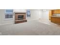 Living room with fireplace, carpet, and access to the kitchen at 7988 Kersey Dr, Indianapolis, IN 46236