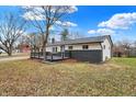 Ranch home with gray and white exterior, a deck, and a tree in the front yard at 11010 Broadway St, Carmel, IN 46280