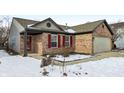 Brick ranch home with a two-car garage and red shutters at 14278 Holly Berry Cir, Fishers, IN 46038