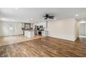 Open concept living room with hardwood floors and kitchen access at 14278 Holly Berry Cir, Fishers, IN 46038