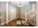 Bright entryway with hardwood floors, a comfy chair, and staircase at 1601 Spruce St, Indianapolis, IN 46203