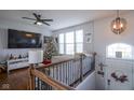 Spacious living room with a cozy Christmas tree and a large TV at 14024 Wimbleton Way, Fishers, IN 46037
