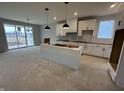 Modern kitchen with white cabinets, a kitchen island, and stainless steel appliances at 20022 Boulder Brook Ln, Westfield, IN 46074