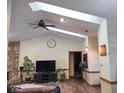 Vaulted ceiling living room with hardwood floors and large TV at 3717 Bridger S Dr, Carmel, IN 46033