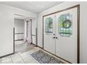 Inviting foyer with decorative glass doors and patterned rug at 409 Lansdowne Rd, Indianapolis, IN 46234