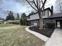 Charming two-story brick home with a walkway and a well-maintained lawn at 409 Lansdowne Rd, Indianapolis, IN 46234