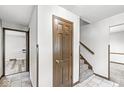 Hallway features tile flooring, wood door, and stairs to upper level at 409 Lansdowne Rd, Indianapolis, IN 46234