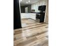 Spacious kitchen showcasing new flooring, stainless steel appliances, and ample counter space at 409 Lansdowne Rd, Indianapolis, IN 46234