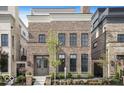 Charming brick home with symmetrical facade, large windows, and professionally landscaped front yard at 467 Rayle Dr, Carmel, IN 46032