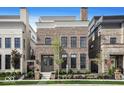 Stately brick home featuring a symmetrical facade, large windows, and manicured landscaping at 467 Rayle Dr, Carmel, IN 46032