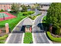 Gated community entrance with landscaping and tennis courts at 8681 Jaffa Court East Dr # 16, Indianapolis, IN 46260