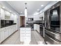 Modern kitchen with white cabinets, granite counters, and stainless steel appliances at 8681 Jaffa Court East Dr # 16, Indianapolis, IN 46260