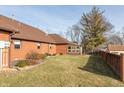 Spacious backyard with a sunroom and a brick wall at 11 Eastern Ave, Brownsburg, IN 46112