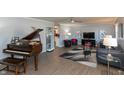 Living room features hardwood floors, a grand piano, and modern decor at 11 Eastern Ave, Brownsburg, IN 46112