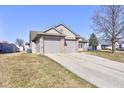 This home features a two-car garage, mature trees, brick accents and low maintenance landscaping at 12216 Laurelwood Ct, Indianapolis, IN 46236