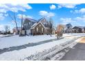 Two-story house with gray siding, brick accents, and a covered porch; winter scene at 1401 W Springhurst Blvd, Greenfield, IN 46140