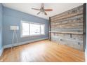 Bright living room with hardwood floors, ceiling fan, and rustic wood wall at 1453 Central Ave, Noblesville, IN 46060