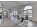 Modern dining room with glass table and grey chairs, wood-look flooring at 2814 Cadogan Dr, Greenwood, IN 46143