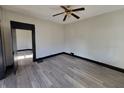 Bright living room with hardwood floors and ceiling fan at 2826 Station St, Indianapolis, IN 46218