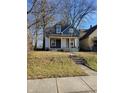 Recently renovated home with gray siding, steps, and a well-maintained lawn at 2955 N Olney St, Indianapolis, IN 46218