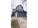 Two-story house with a gray and white exterior, attached garage, and a red front door at 4059 Eagle Cove W W Dr, Indianapolis, IN 46254