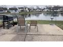 Small patio with grill and chairs overlooking a pond at 4059 Eagle Cove W W Dr, Indianapolis, IN 46254
