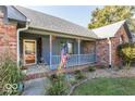 Inviting front porch with American flag and decorative railings at 5856 Cozy Dr, Pittsboro, IN 46167