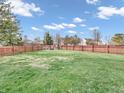 Large grassy backyard with a red wooden fence at 6451 E Aberdene Ct, Camby, IN 46113