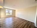 Spacious living room featuring hardwood floors and a large window at 7043 Tyler Ln, Indianapolis, IN 46217