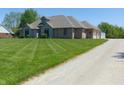 View of the home and gravel driveway showcases the home's setting at 7099 S 1100 W, Jamestown, IN 46147
