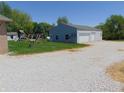 Large outbuilding with white garage doors offers ample storage and workspace at 7099 S 1100 W, Jamestown, IN 46147