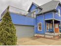 Two-story blue house with gray trim, a detached garage, and a rooftop deck at 114 N Oriental St, Indianapolis, IN 46202