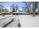 White ranch home with black garage doors and landscaping at 11930 Old Orchard Dr, Indianapolis, IN 46236