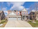 Two-story home with gray and red siding, attached two-car garage, and landscaping at 16172 Sedalia Dr, Fishers, IN 46040