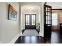 Bright and spacious entryway with dark hardwood floors and french doors at 16845 Downstream Dr, Westfield, IN 46062