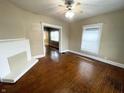 Living room with hardwood floors, a fireplace, and a view to another room at 2817 N New Jersey St, Indianapolis, IN 46205