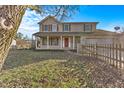 Two-story house with front porch and picket fence at 3 Lakewood Dr, Trafalgar, IN 46181