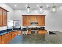 Modern kitchen showcasing granite counters, stainless appliances, and stylish pendant lights at 304 N College Ave # Apt A, Indianapolis, IN 46202