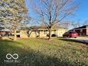 Ranch home with a large front yard and mature trees at 3429 Central Ave, Columbus, IN 47203