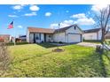 House with American flag, grassy yard, and driveway at 4193 Sycamore Ct, Franklin, IN 46131