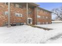 Brick building exterior with entrance, walkway, and snow at 5038 Allisonville Rd # A, Indianapolis, IN 46205