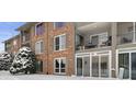 Brick building exterior with balconies and snowy landscape at 5038 Allisonville Rd # A, Indianapolis, IN 46205