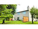 Spacious backyard with privacy fence, mature trees, and outdoor living area at 5340 Thompson Park Blvd, Indianapolis, IN 46237