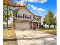 Two-story house with red shutters, brick accents, and a large yard at 5340 Thompson Park Blvd, Indianapolis, IN 46237